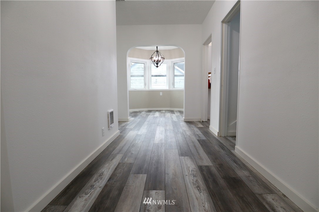 305 Fillmore Street Hoquiam, WA 98550 - Photo 9 of 23 wooden floor in an empty room with a window