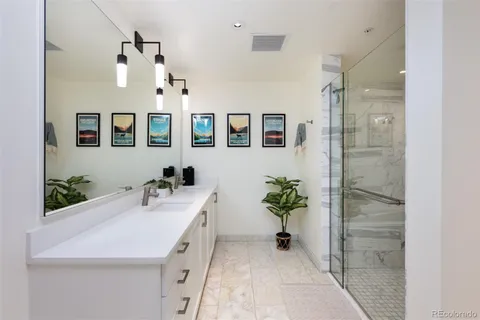 a bathroom with a sink a mirror and a shower