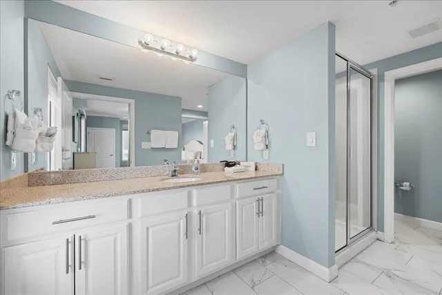 a bathroom with a granite countertop sink mirror and