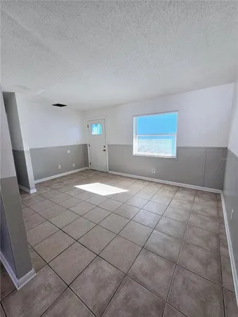 a view of a livingroom with wooden floor and window