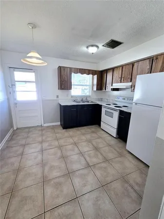 a kitchen with stainless steel appliances granite countertop a sink and a refrigerator