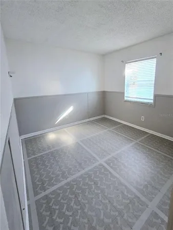 an empty room with windows and closet