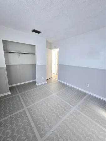 a view of an empty room with a closet