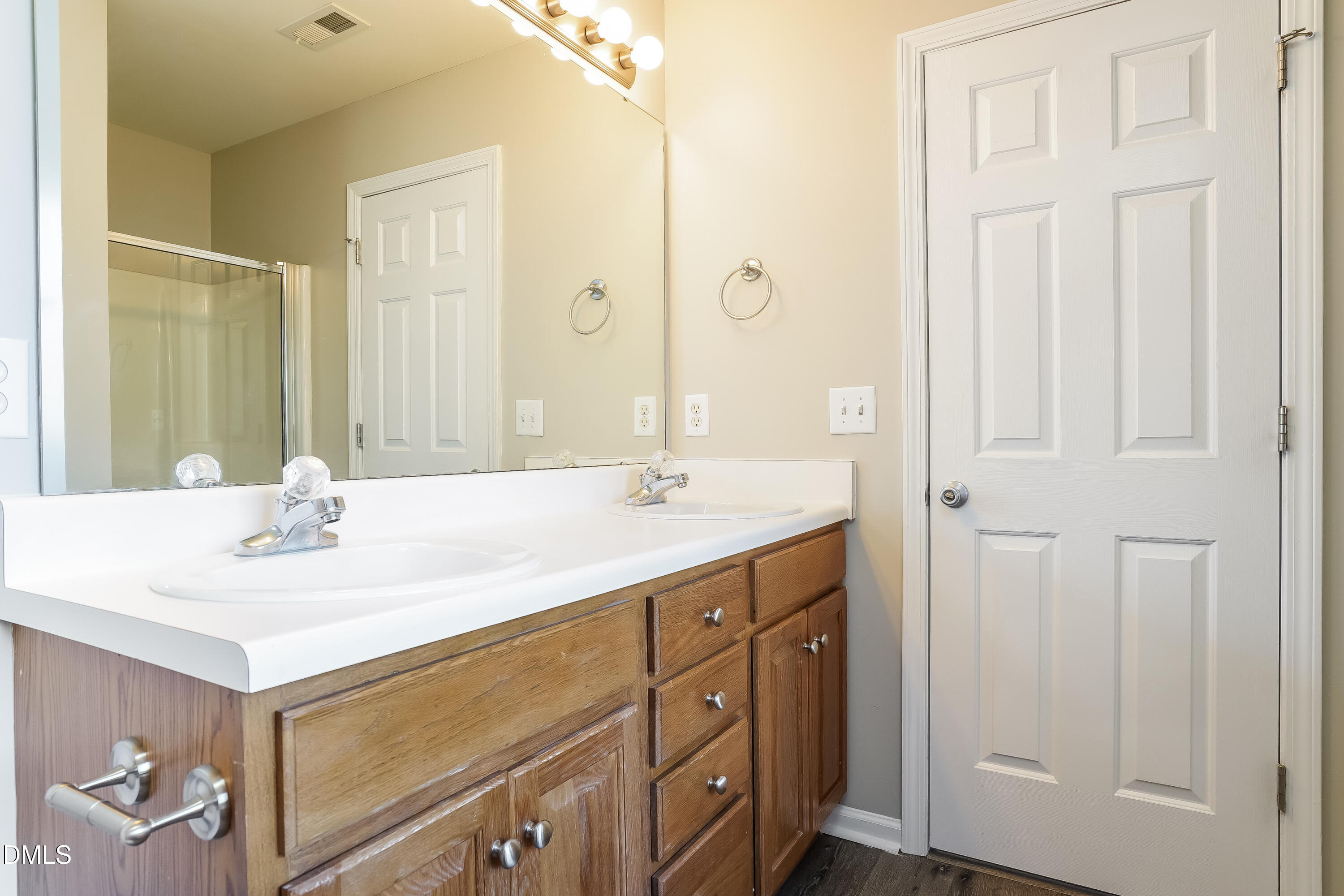 7109 Bristoe Station Lane Raleigh, NC 27610 - Photo 13 of 17 a bathroom with a double vanity sink and a mirror