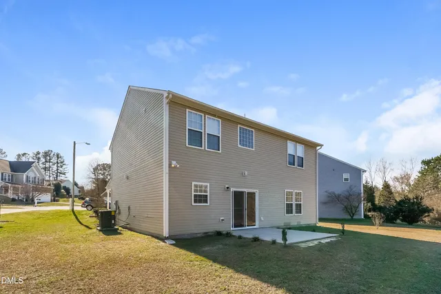 a backyard of a house with table and chairs