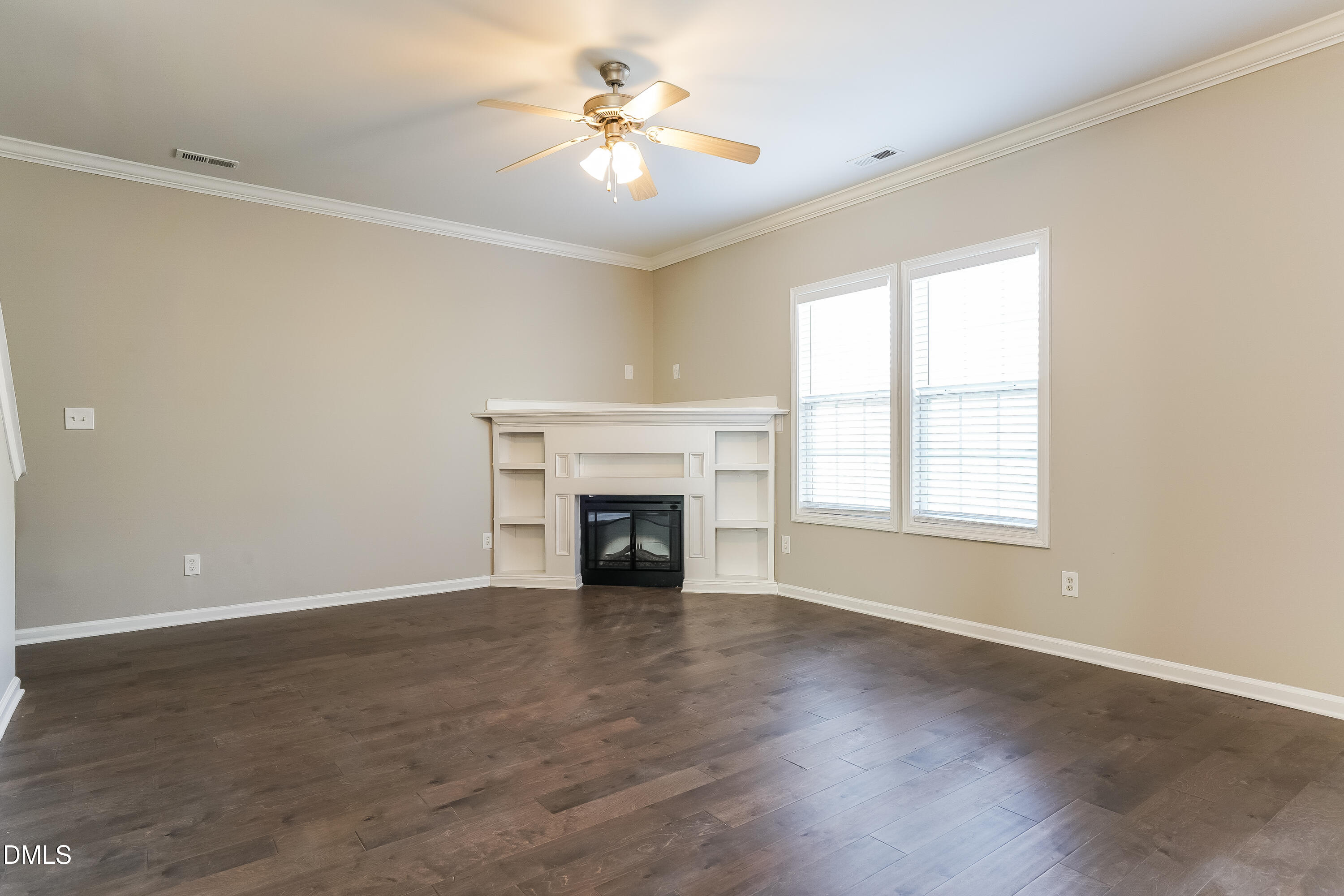 7109 Bristoe Station Lane Raleigh, NC 27610 - Photo 3 of 17 an empty room with windows fireplace and a sink