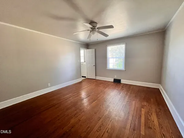 wooden floor in an empty room with a window