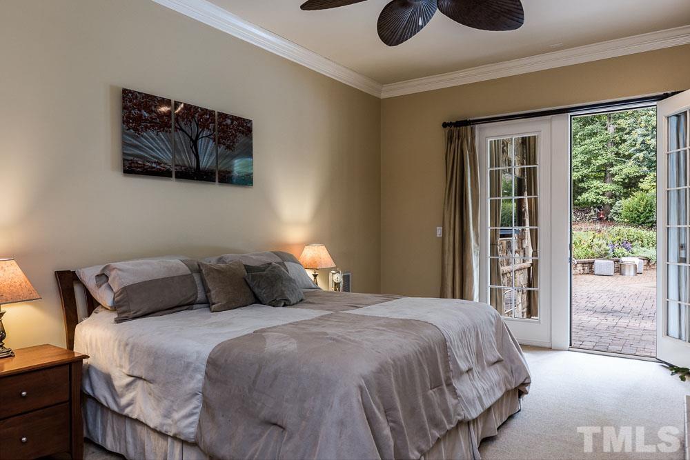 5204 Atherton Bridge Road Raleigh, NC 27613 - Photo 13 of 27 a bedroom with a large bed and a large window