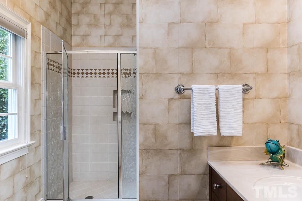 5204 Atherton Bridge Road Raleigh, NC 27613 - Photo 18 of 27 a bathroom with a granite countertop shower