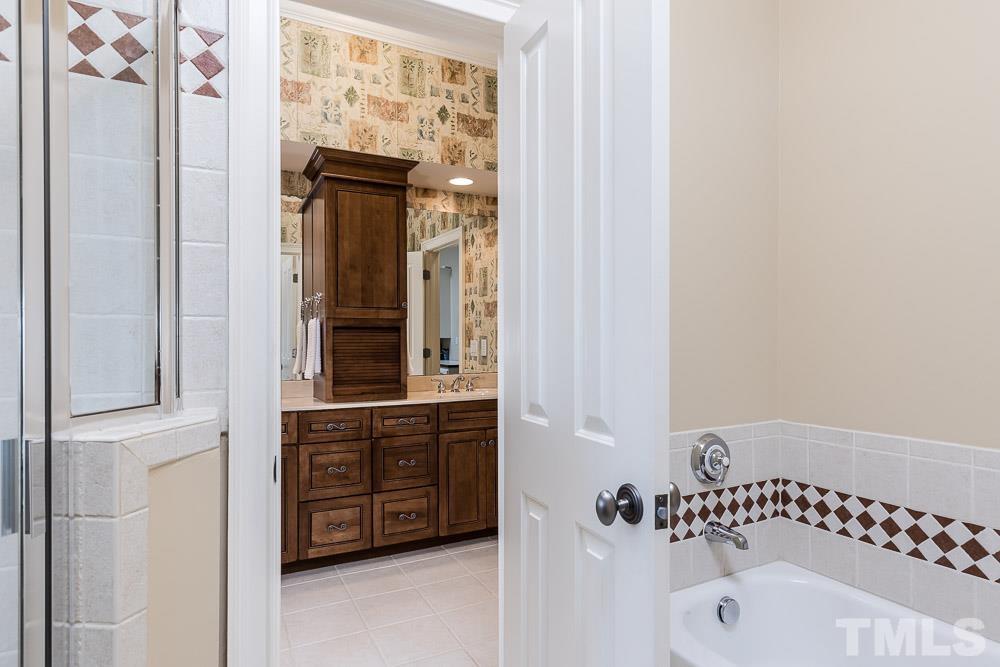 5204 Atherton Bridge Road Raleigh, NC 27613 - Photo 24 of 27 a bathroom with a bathtub and a shower