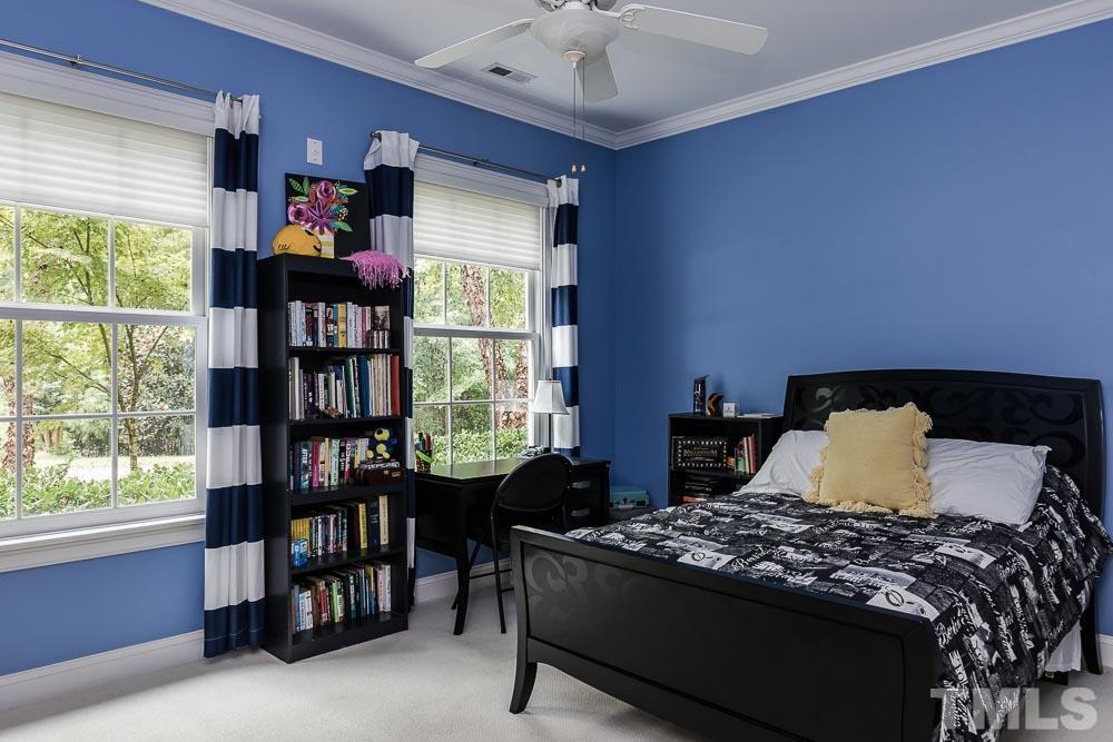 5204 Atherton Bridge Road Raleigh, NC 27613 - Photo 27 of 27 a bedroom with a bed furniture and a book shelf