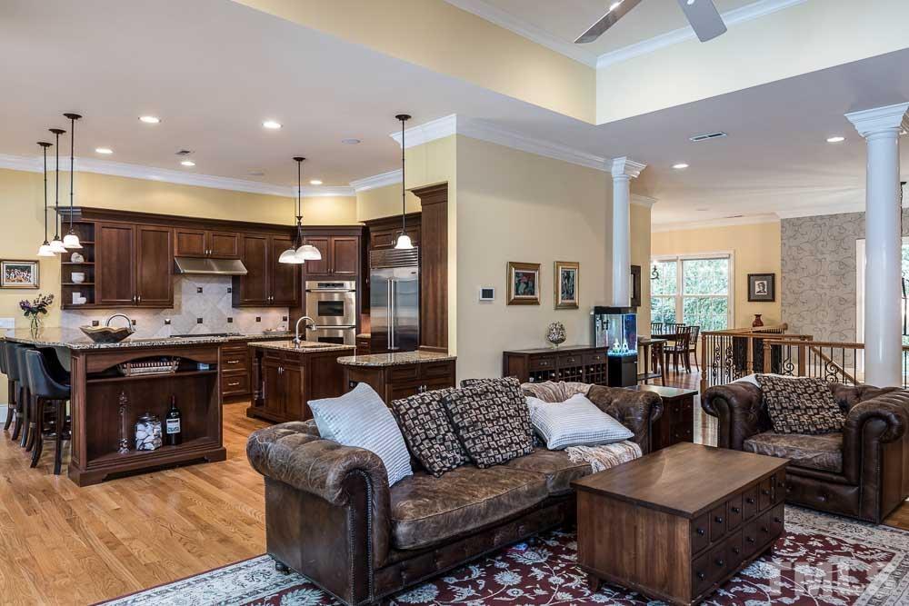 5204 Atherton Bridge Road Raleigh, NC 27613 - Photo 8 of 27 a large living room with a couch and kitchen view