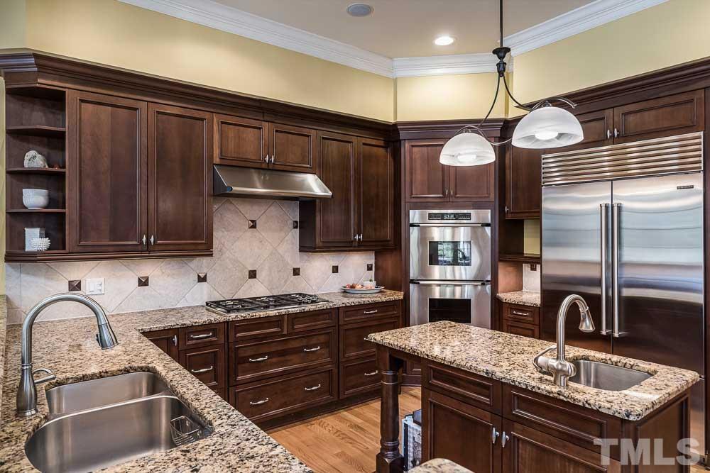 5204 Atherton Bridge Road Raleigh, NC 27613 - Photo 9 of 27 a kitchen with a stove a sink and cabinets