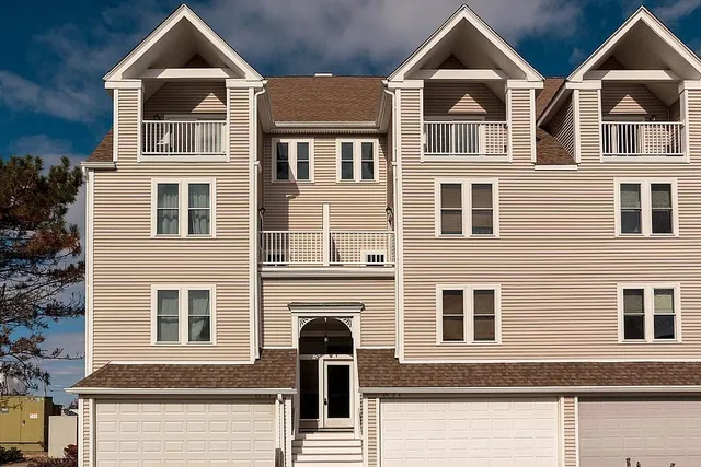 a front view of a house with many windows