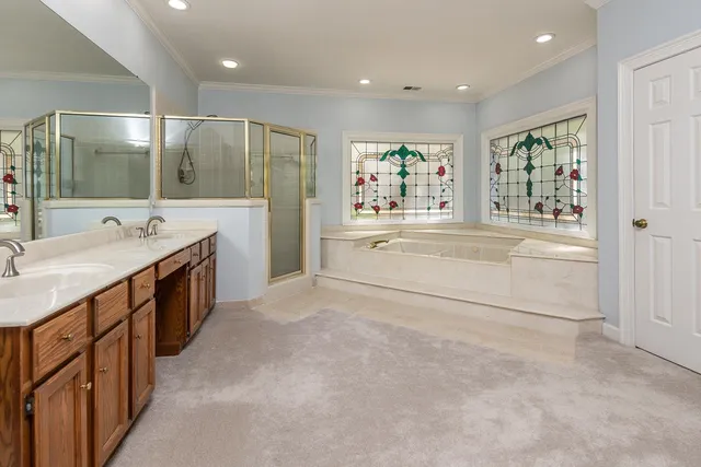 a spacious bathroom with a shower sink and mirror