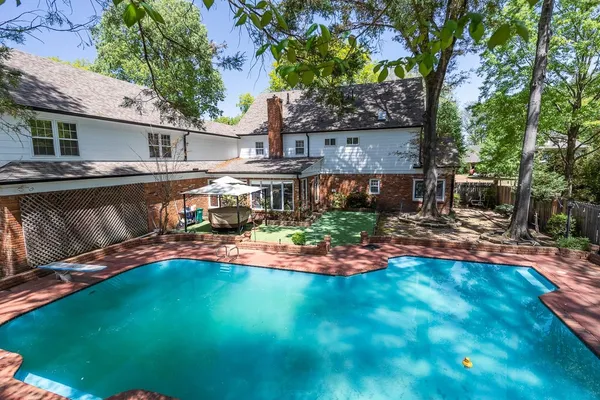 a view of a swimming pool with a outdoor seating
