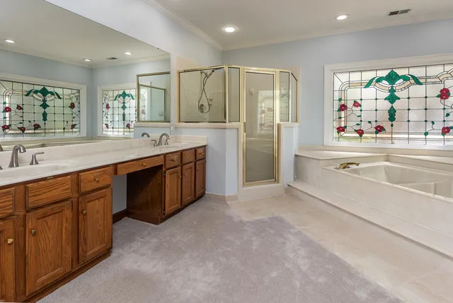 a spacious bathroom with a tub sink and mirror