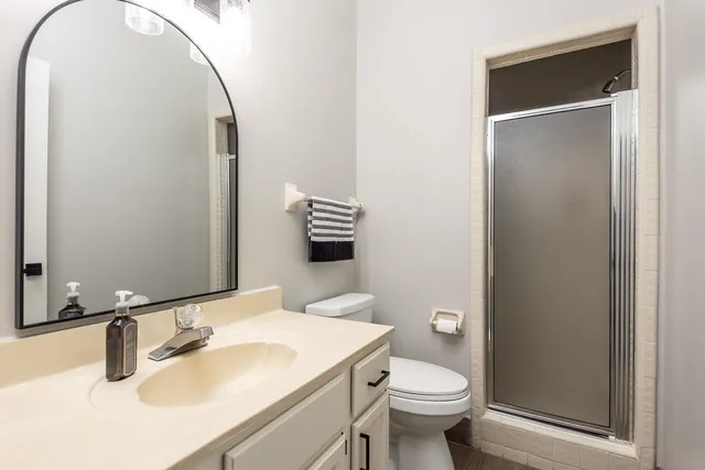 a bathroom with a sink toilet and mirror