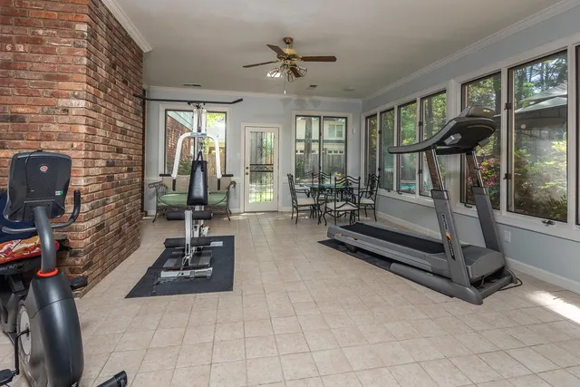 a living room with furniture a flat screen tv and a floor to ceiling window