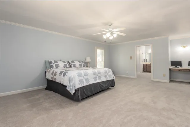 a spacious bedroom with a bed and a chandelier