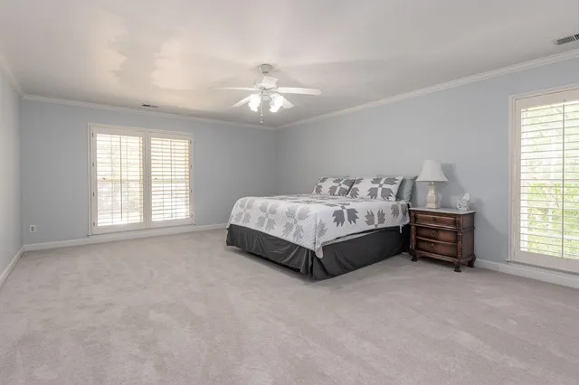 a spacious bedroom with a bed and a window