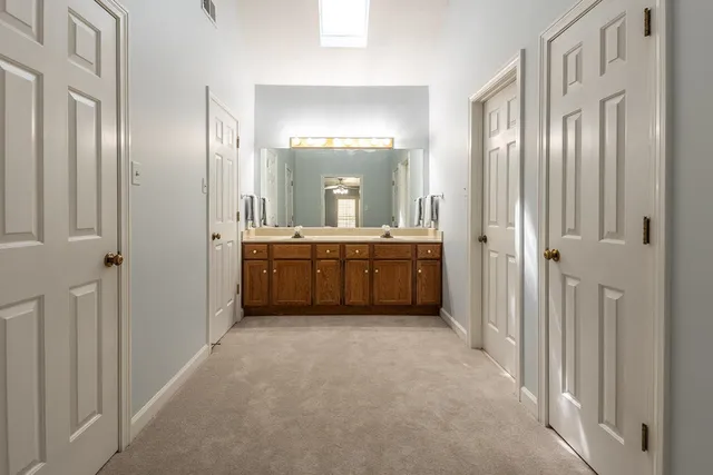 a bathroom with a double vanity sink mirror and toilet