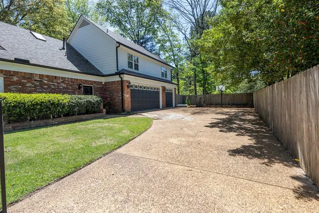 a front view of a house with a yard and pathway