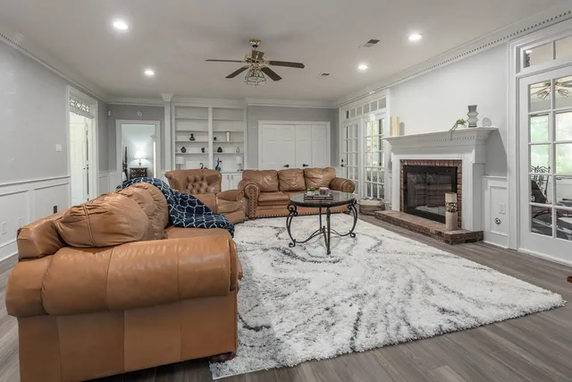 a living room with furniture and a fireplace