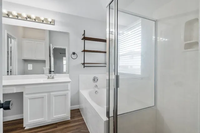 a bathroom with a granite countertop sink a toilet and shower