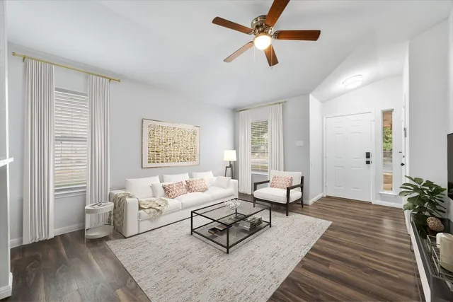 a living room with furniture and wooden floor