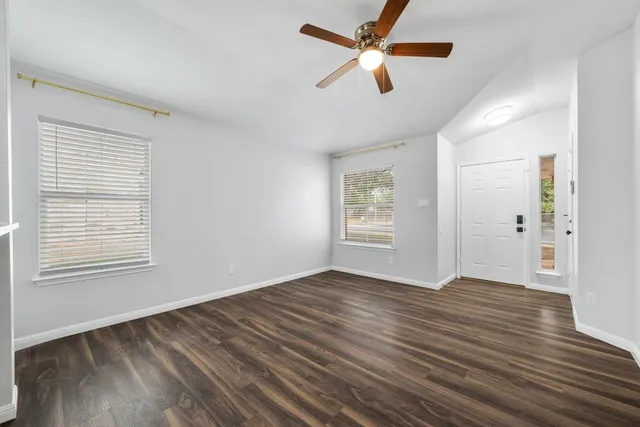 wooden floor in an empty room with a window