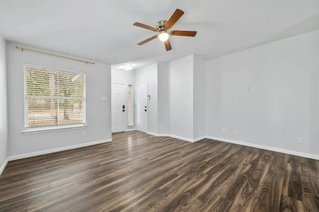 wooden floor in an empty room with a window