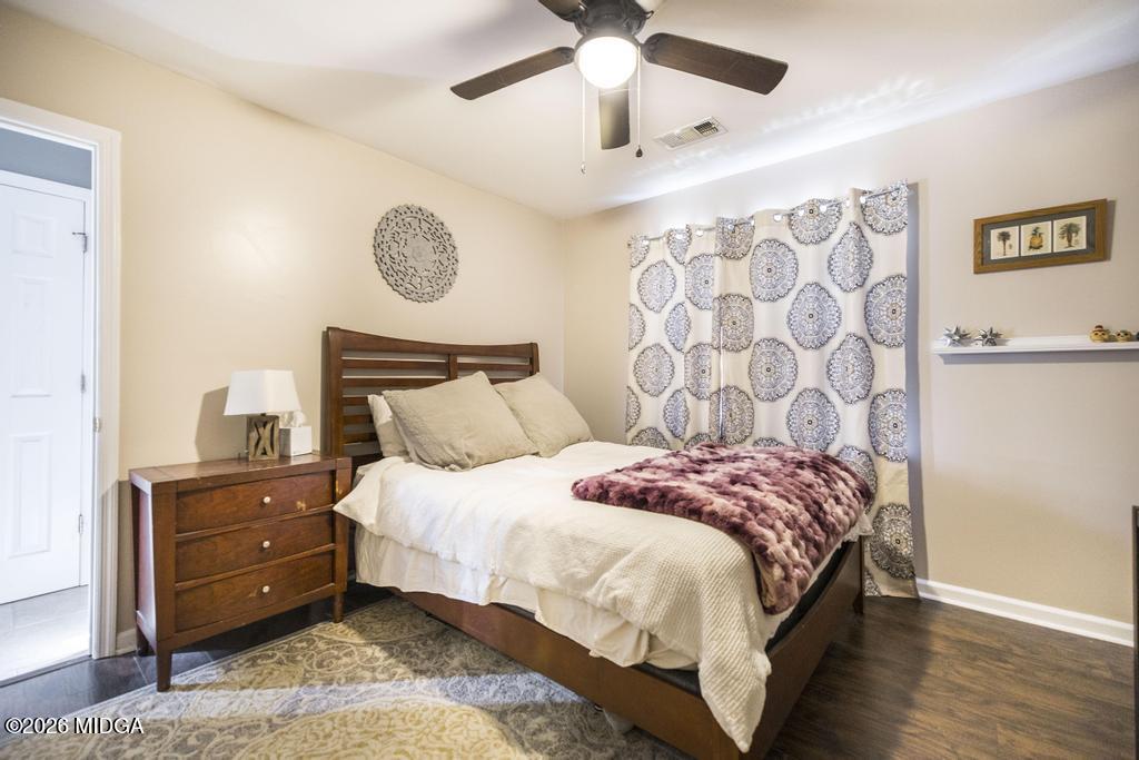 128 Springwood Court Macon, GA 31210 - Photo 16 of 21 a bedroom with a bed and a chandelier