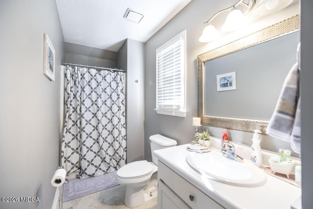 128 Springwood Court Macon, GA 31210 - Photo 17 of 21 a bathroom with a sink toilet and a mirror
