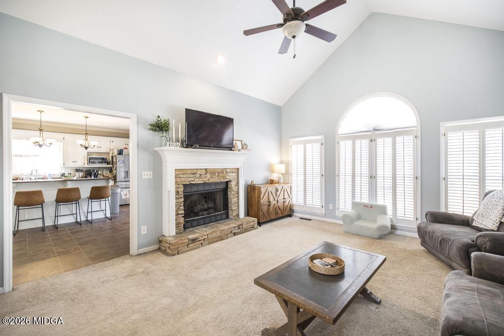 128 Springwood Court Macon, GA 31210 - Photo 2 of 21 a living room with furniture a fireplace and a flat screen tv