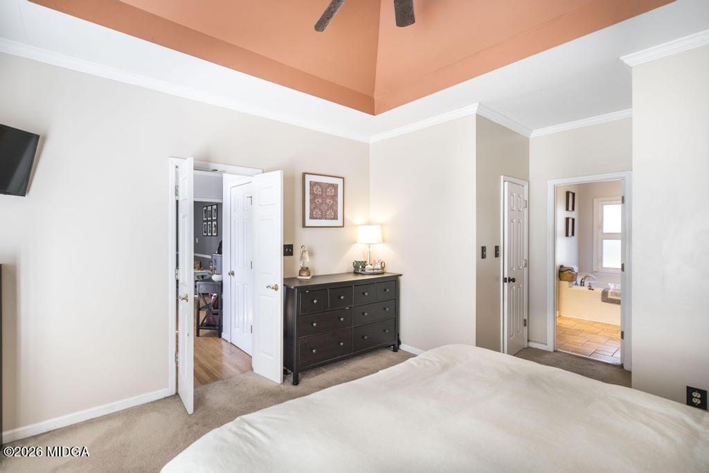 128 Springwood Court Macon, GA 31210 - Photo 9 of 21 a spacious bedroom with a bed and a chandelier