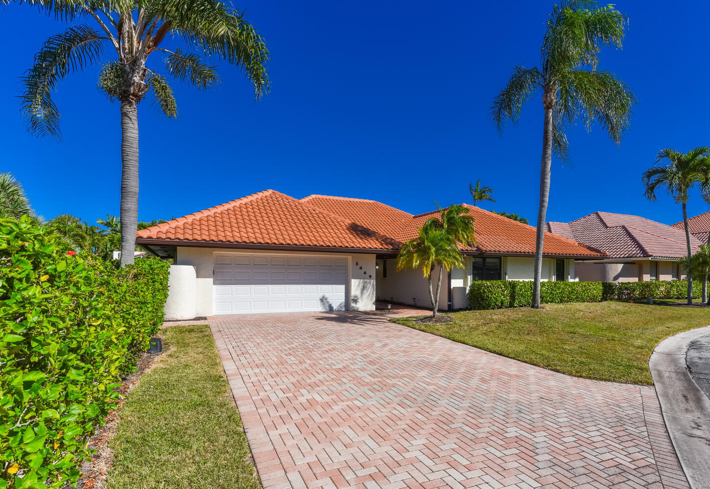 1469 Vía Privada Jupiter, FL 33477 - Photo 1 of 38 a front view of a house with a yard and potted plants