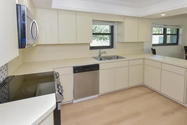 a kitchen with refrigerator and window