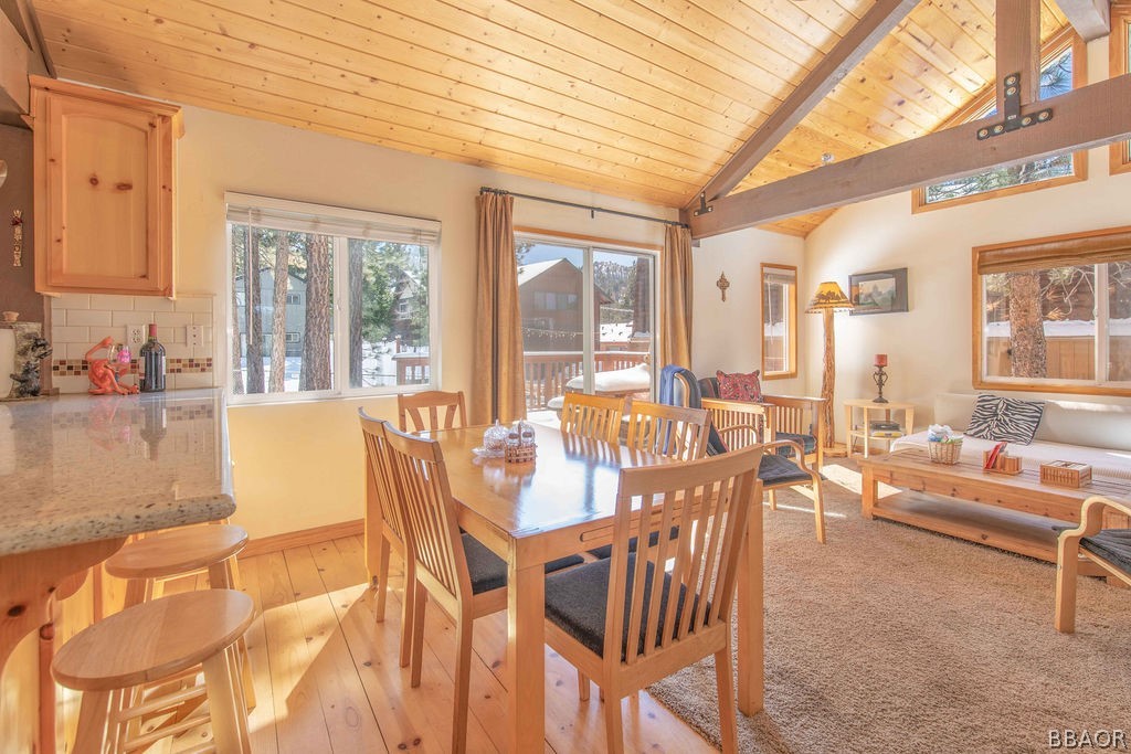 43132 Moonridge Road Big Bear Lake, CA 92315 - Photo 12 of 41 a view of a dining room with furniture large windows and wooden floor