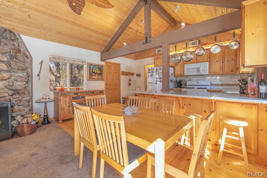 43132 Moonridge Road Big Bear Lake, CA 92315 - Photo 13 of 41 a view of a dining room with furniture a chandelier and a table