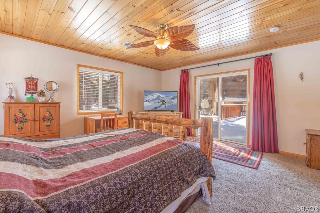 43132 Moonridge Road Big Bear Lake, CA 92315 - Photo 22 of 41 a bedroom with a bed and glass windows