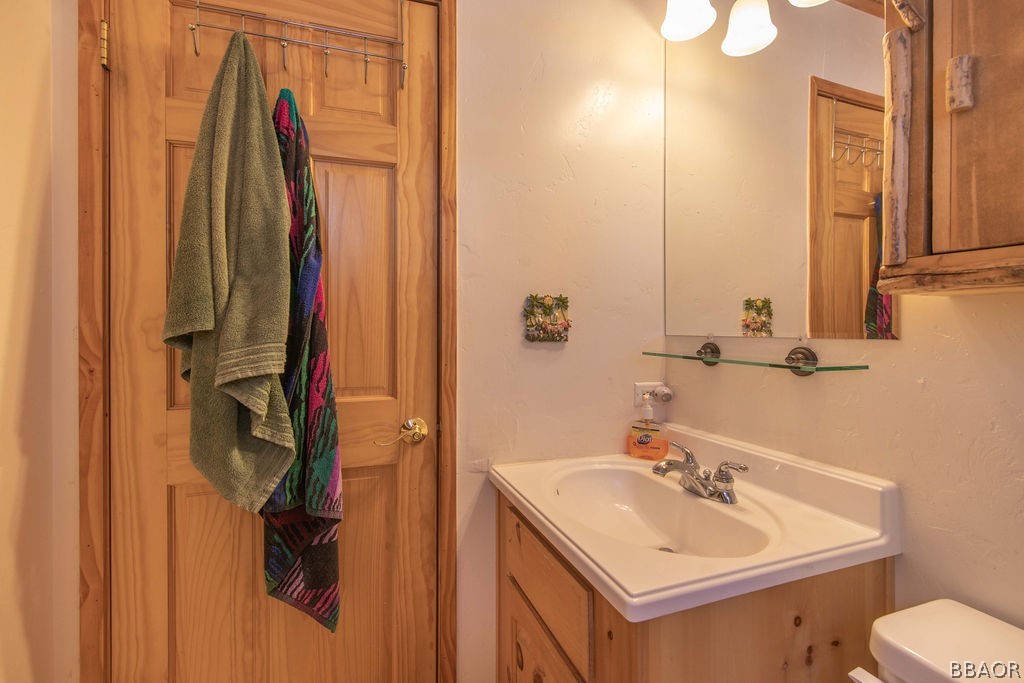 43132 Moonridge Road Big Bear Lake, CA 92315 - Photo 28 of 41 a bathroom with a sink toilet and mirror