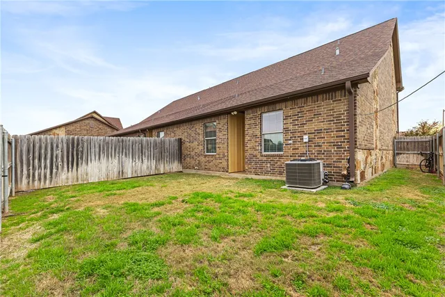 a backyard of a house with table and chairs