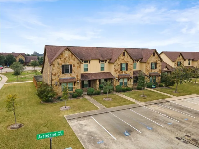 a view of houses with swimming pool