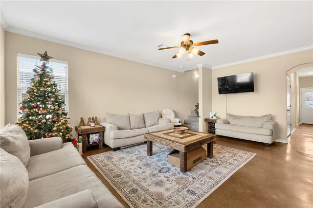 a living room with furniture and a flat screen tv