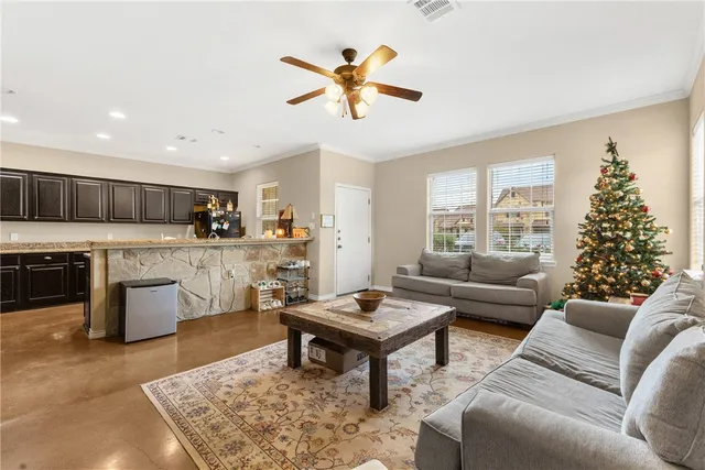 a living room with furniture and kitchen view