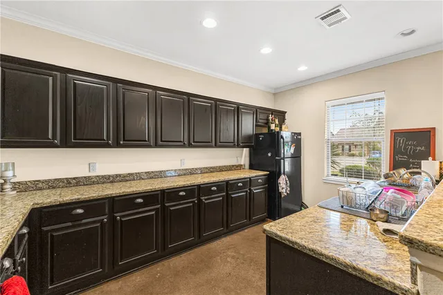 a kitchen with granite countertop stainless steel appliances and wooden cabinets