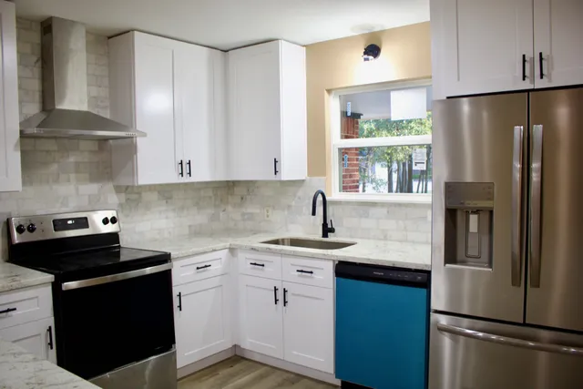 a kitchen with a sink stove and refrigerator