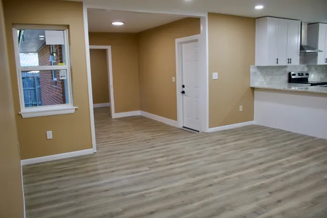 a view of kitchen with wooden floor and electronic appliances