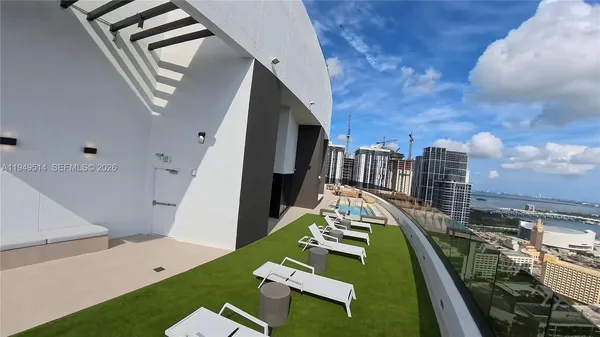 a view of a house with pool and chairs